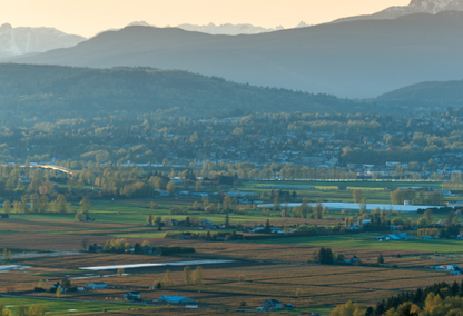 cultivated fields and the rocky mountains in the background in Abbotsford, British Columbia